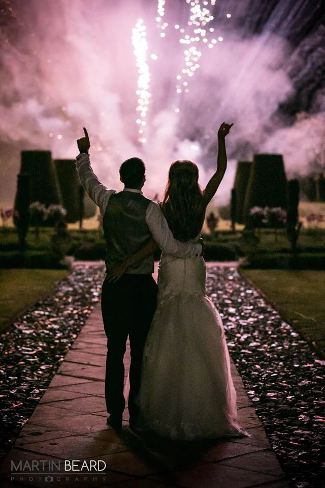A wedding couple enjoying watching a HEXTech Firer fired fireworks display by HEX Fireworks.